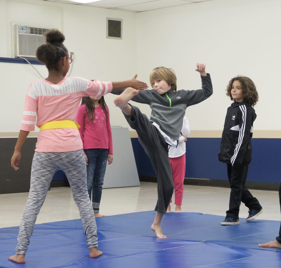 Young Teodojo students practicing self-defense together
